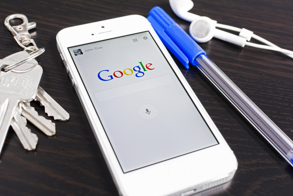 iphone on google homepage, pen and keys